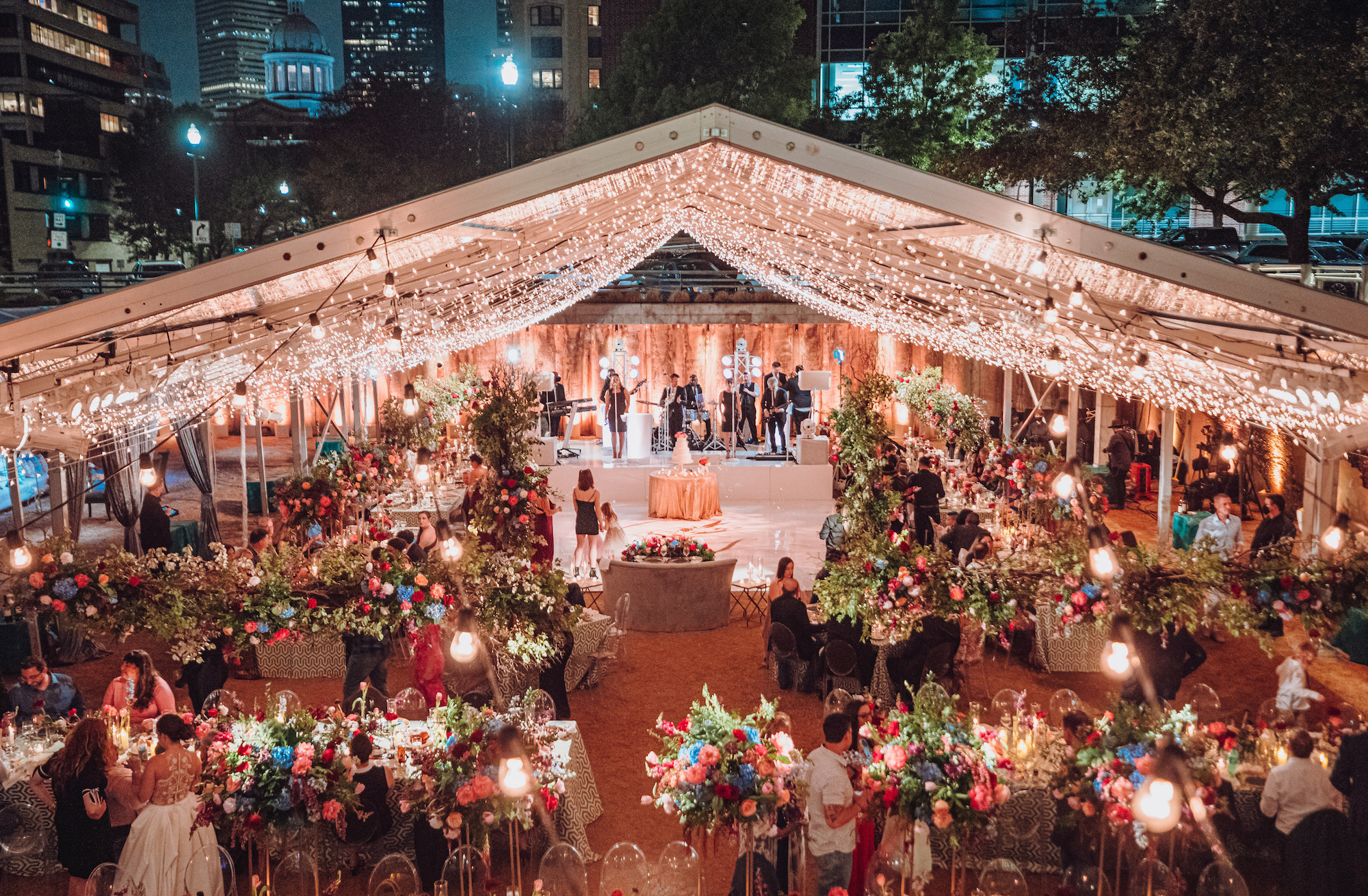 A whimsical tent wedding full of flowers and twinkling lights in Houston, TX.