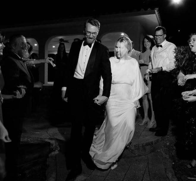 Bride and groom walk hand in hand after their Sarasota FL wedding