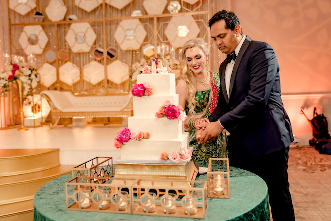 Bride and groom cutting the cake.