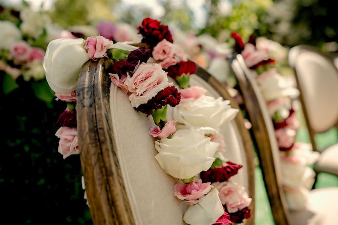 Close-up shot of the pink, white and red florals positioned on a chair.