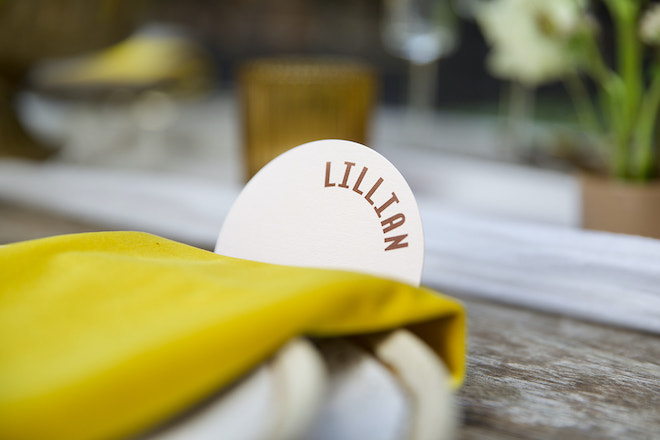 A yellow napkin with a name tag reading "Lillian".