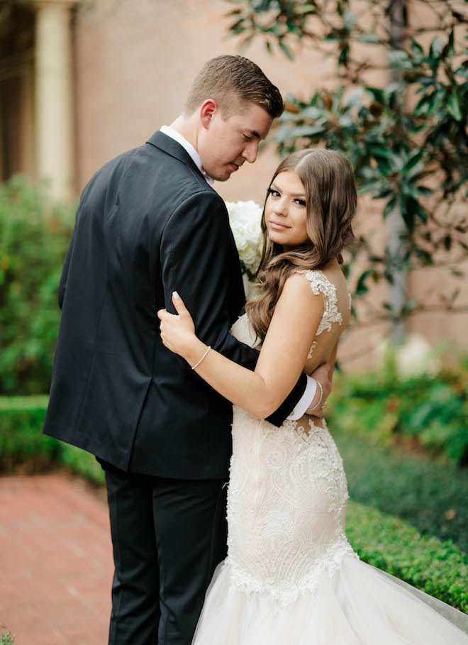 Bride and groom embrace after their black tie wedding ceremony in Houston, Texas.