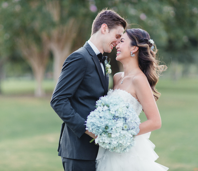 Groom and bride laugh and smile on the Pine Forest Country Club golf course.