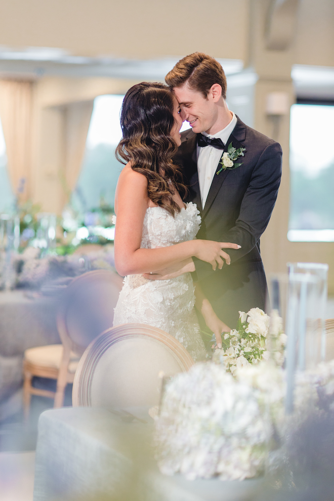 Bride and groom hold each other at their vow renewal in the Legacy ballroom at Pine Forest Country Club