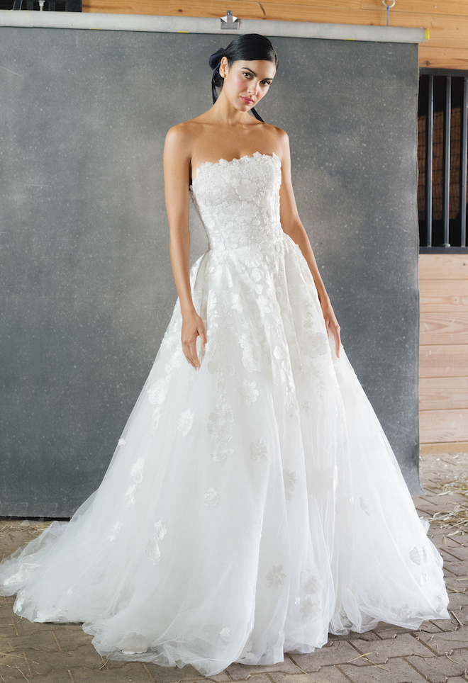 Model wearing a strapless wedding dress designed by Anne Barge for her 2023 fall collection.