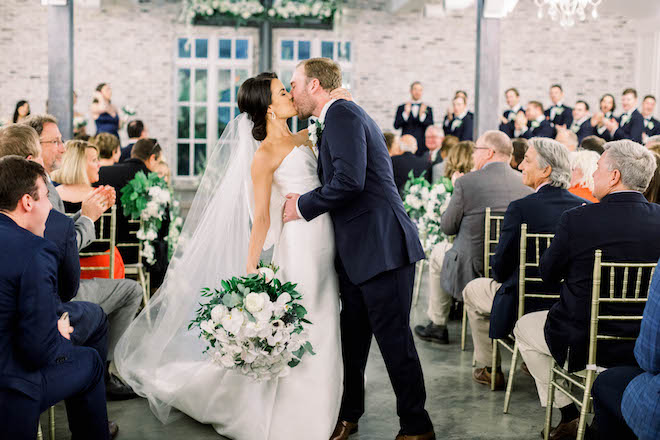 The bride and groom kiss after their chapel ceremony.