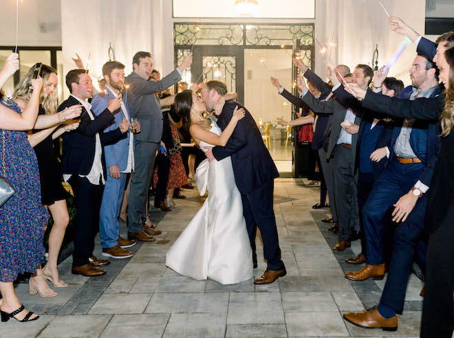 The couple kiss during their sparkler send off at The Peach Orchard venue.