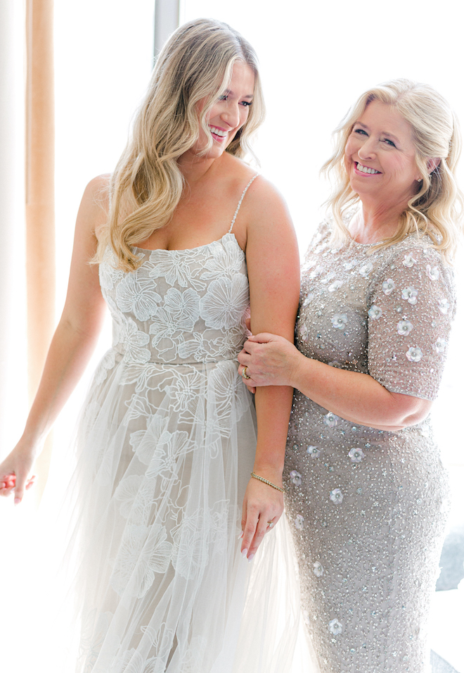 The bride and her mother smiling as they get ready for the ceremony. 