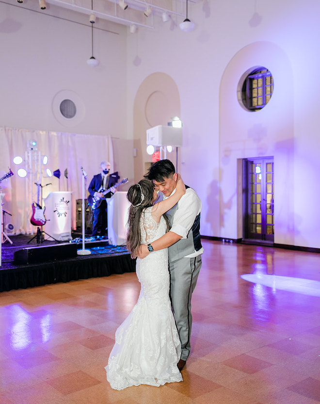 The bride and groom slow dancing at their reception.