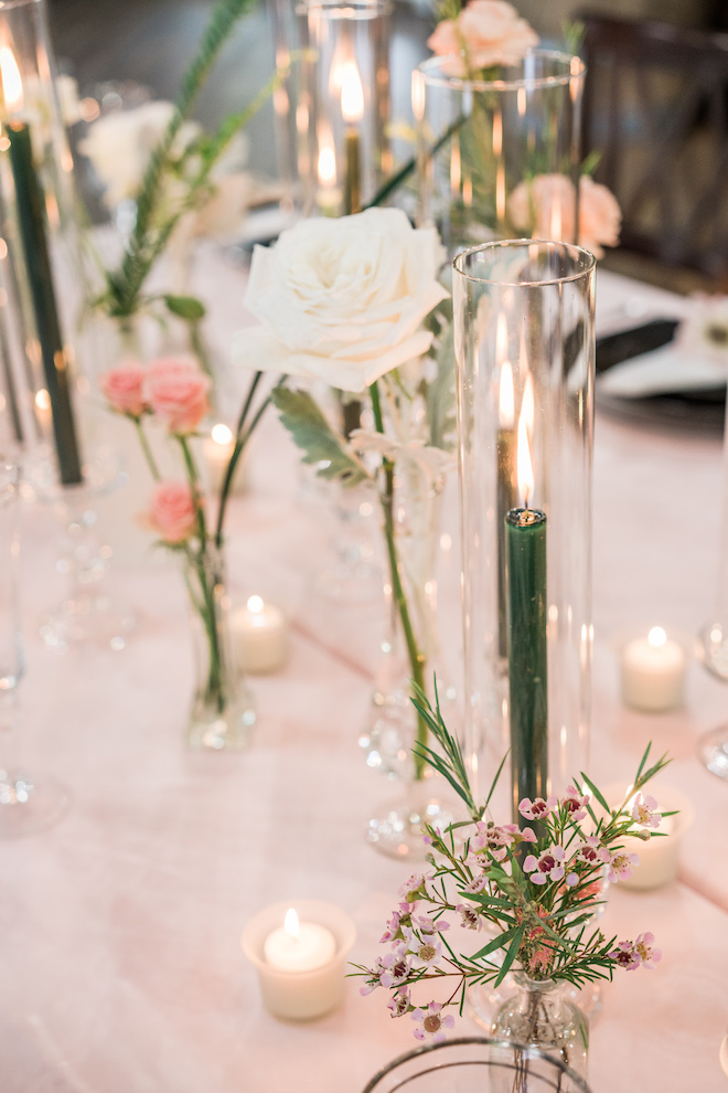 Green candles and flowers on the table creating the garden-theme.