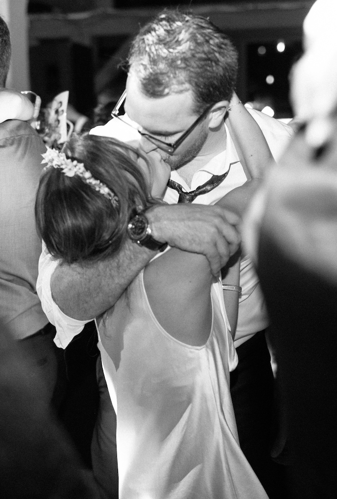 The bride and groom kissing on the dance floor. 