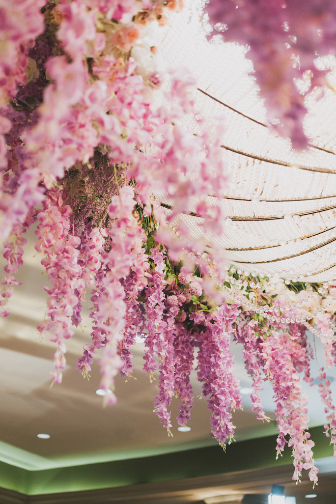 Purple wisteria draping from a chandelier.