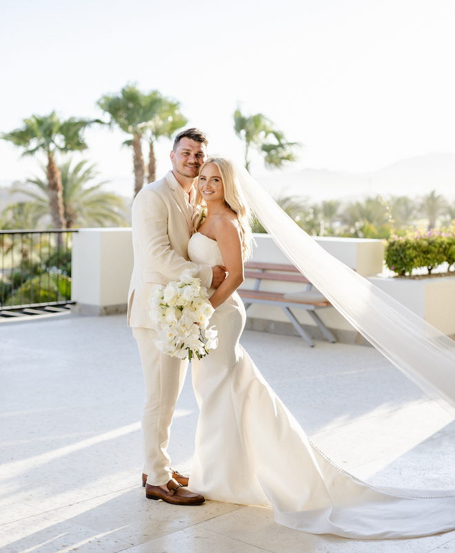 The bride and groom smiling at their tropical destination wedding in Los Cabos.