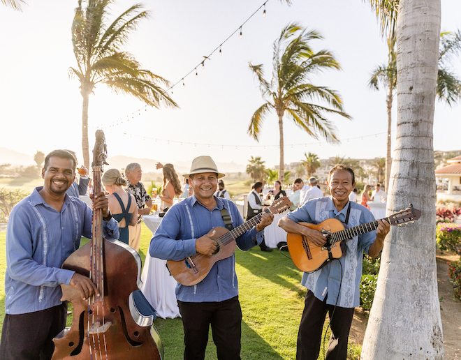 Three men playing music at the alfresco reception.