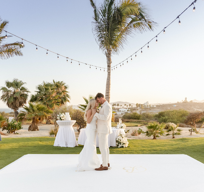 The bride and groom dancing at their tropical wedding reception.