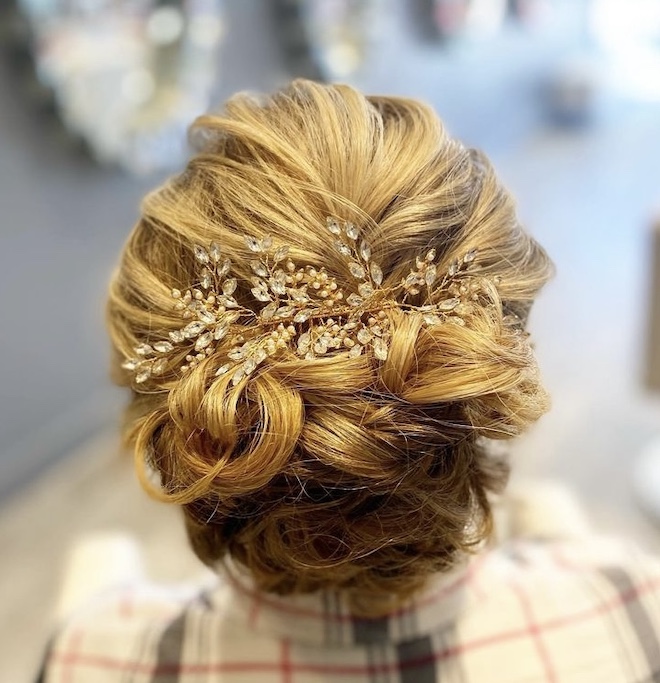 Blonde updo with a jeweled accessory.