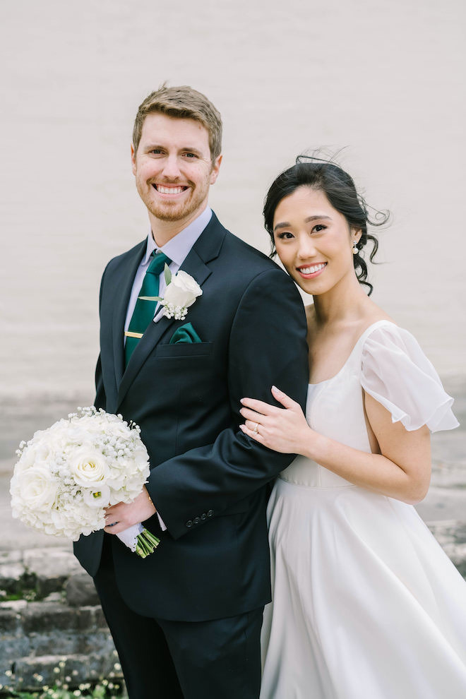 The bride and groom smiling at their downtown boutique hotel wedding.