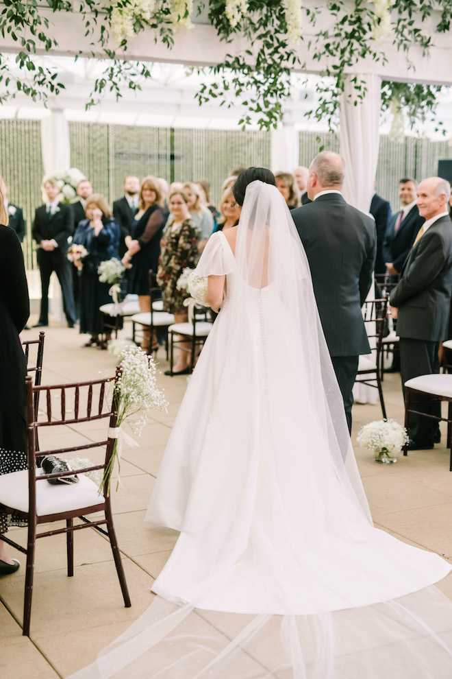 The bride and her father walking down the aisle.