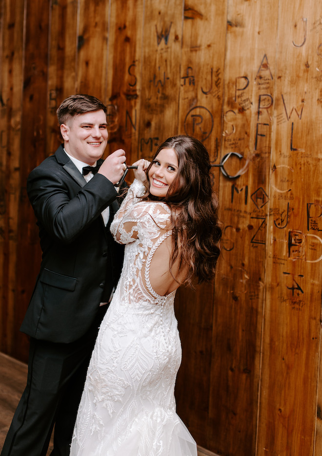 The bride and groom brand the wall at the Brenham wedding venue.