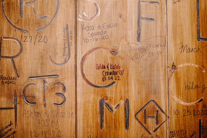 Gilda and Kaleb's brand on the wall of the Brenham venue, Deep in the Heart Farms.