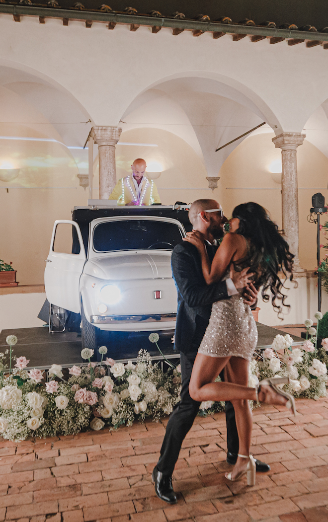 The bride and groom kissing at their reception.