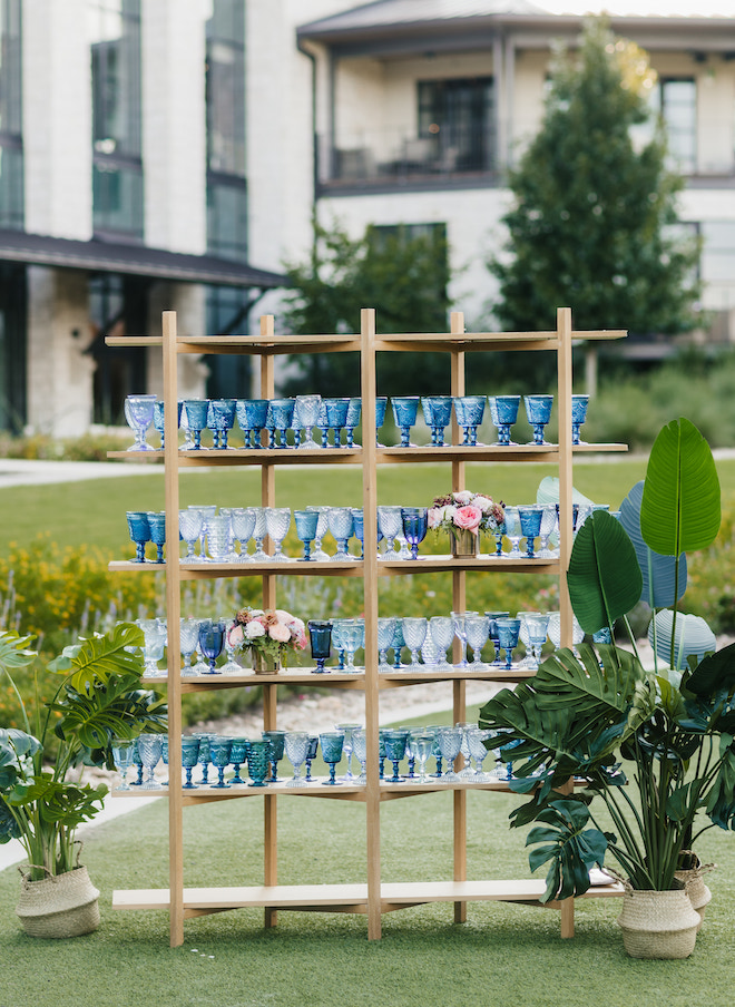 A shelf holding blue glasses