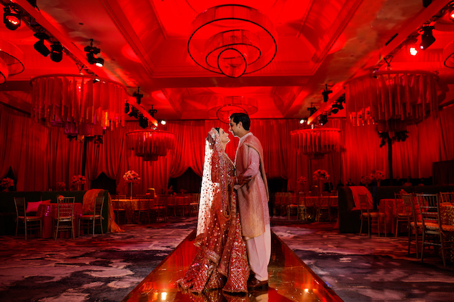 The bride and groom looking at each other in the ballroom of The Post Oak Hotel.