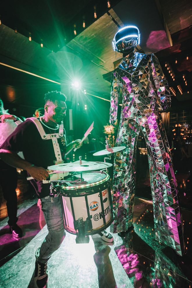 A robot and man playing the drums at the Hora Loca.