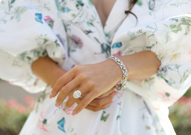 The bride shows off her oval-shaped diamond ring and diamond bracelet on her hand and wrist from Shaftel Diamonds. 