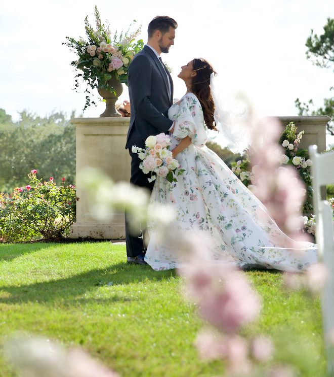 The bride and groom facing each other at their romantic ceremony set up.