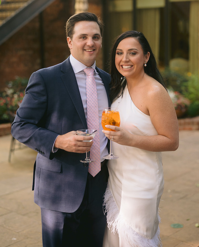 The couple smiling at their rehearsal dinner.