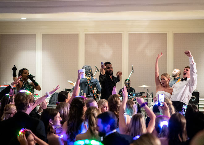 The bride and groom on stage with the band, EastCoast Entertainment.