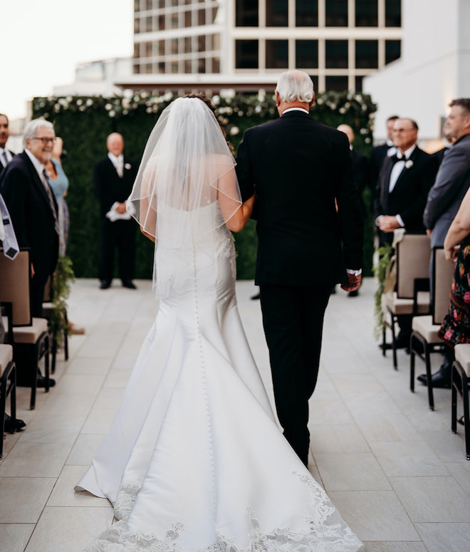 The bride and her father walking down the aisle.