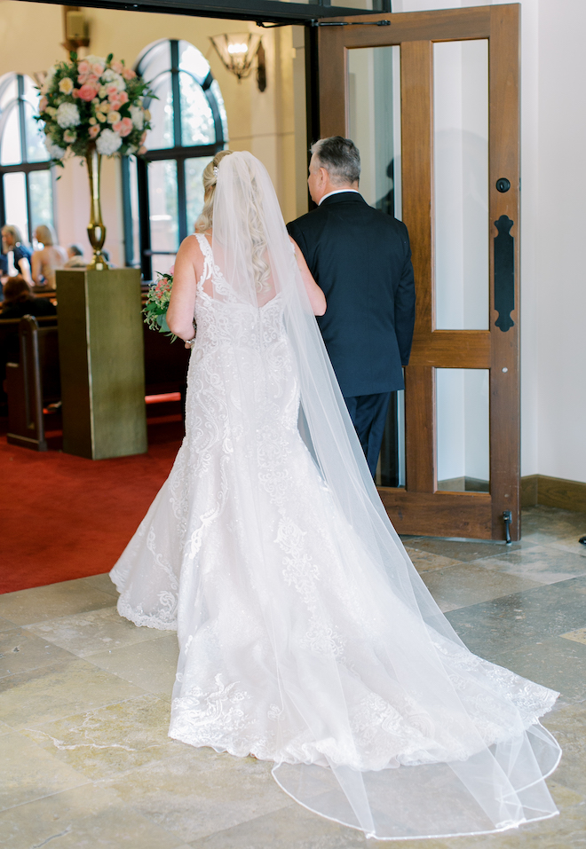 The bride and her father about to walk down the aisle. 