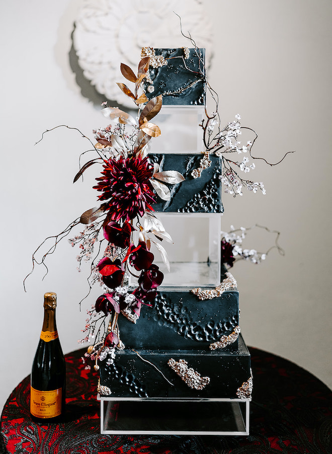 A six-tier acrylic wedding cake detailed in florals designed by Susie's Cakes. 