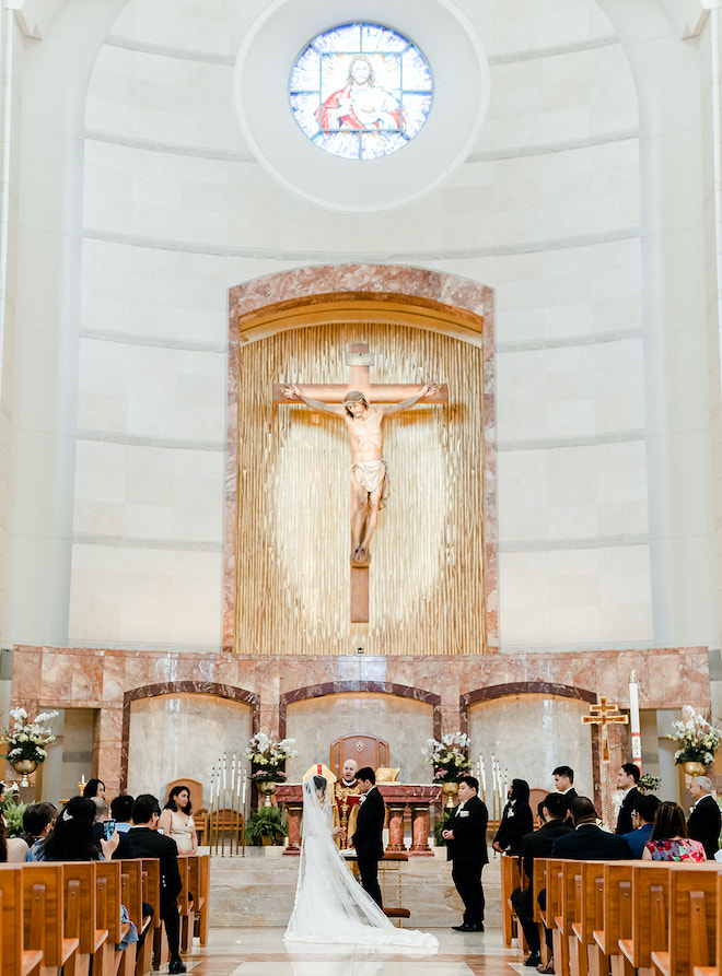 The bride and groom at the altar during their intimate wedding ceremony.