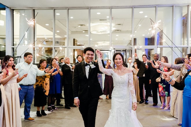 The bride and groom smiling during their sparkler send off.