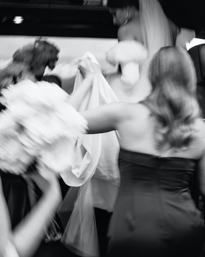 The bride and her bridesmaids getting into a bus before the wedding.