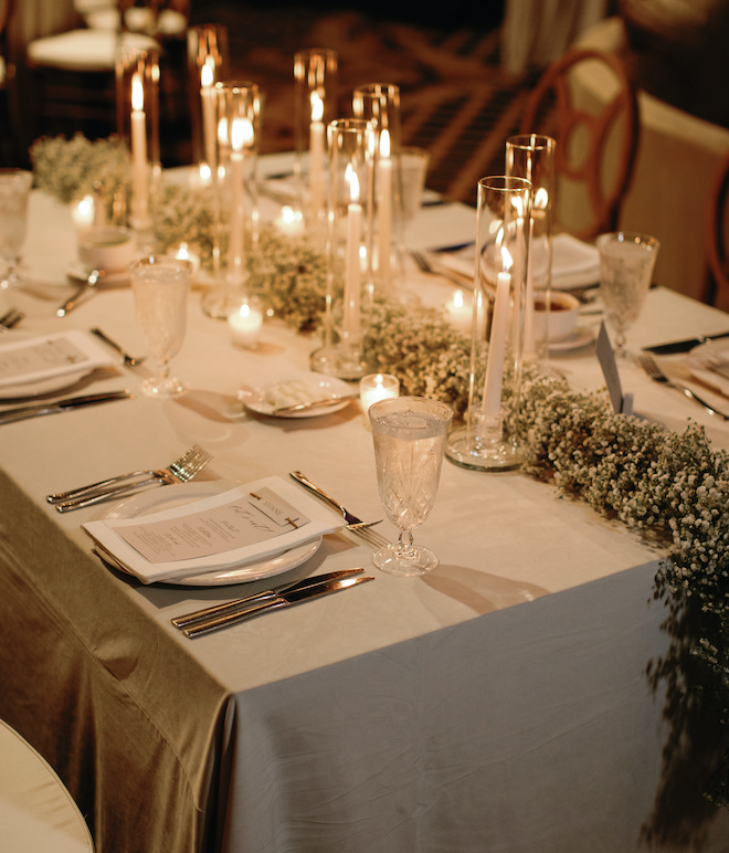 Candlelight and baby's breath decorating the reception tables at a wedding in the San Antonio hill country.