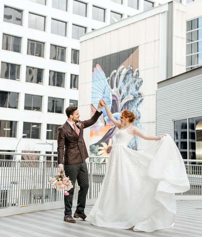 The groom spinning the bride on the rooftop of The Laura Hotel.