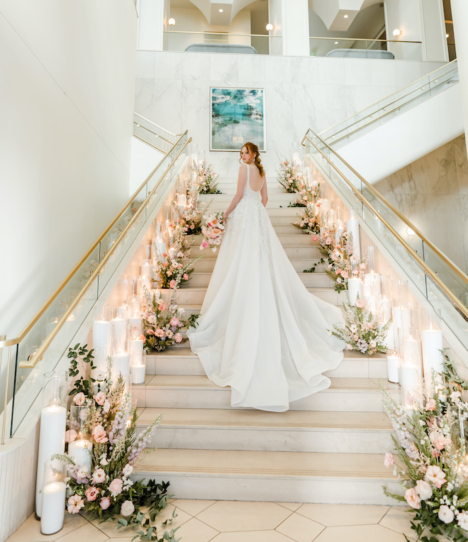 The grand staircase lined with florals and candlelight.