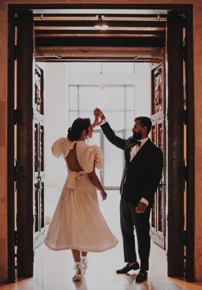 The groom twirling the bride during their engagement session.