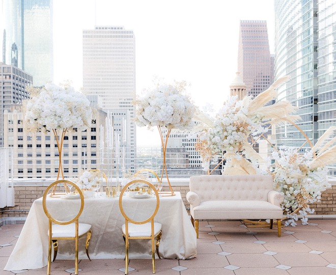 White and gold table decor and florals on the rooftop of Le Meridien.