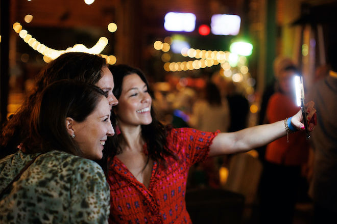 Three women smiling for a selfie.