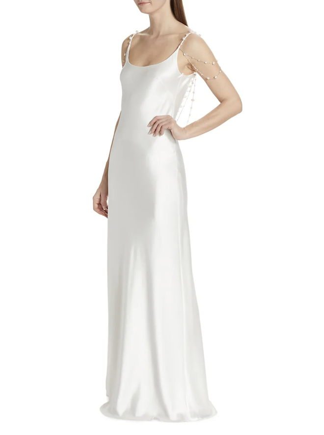 A white slip gown with pearl embellished sleeves.