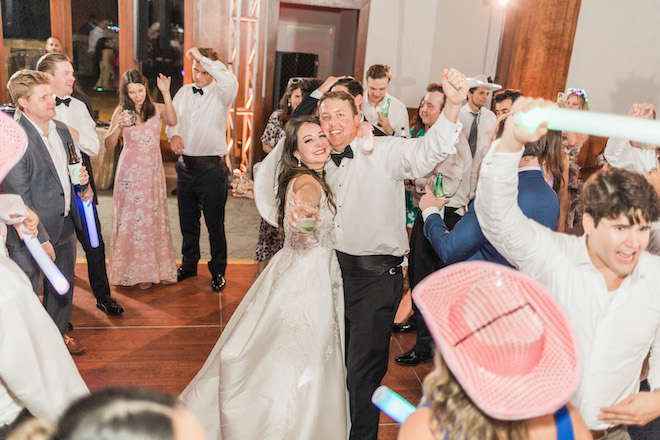 The bride and groom smiling on the dance floor at the reception.