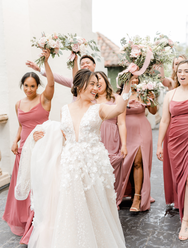 The bride walking with her bridesmaids behind her. 