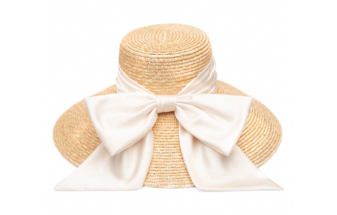 A straw hat with a satin cream bow.