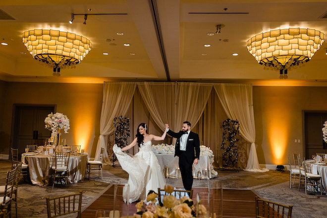 The bride and groom dancing in the ballroom.