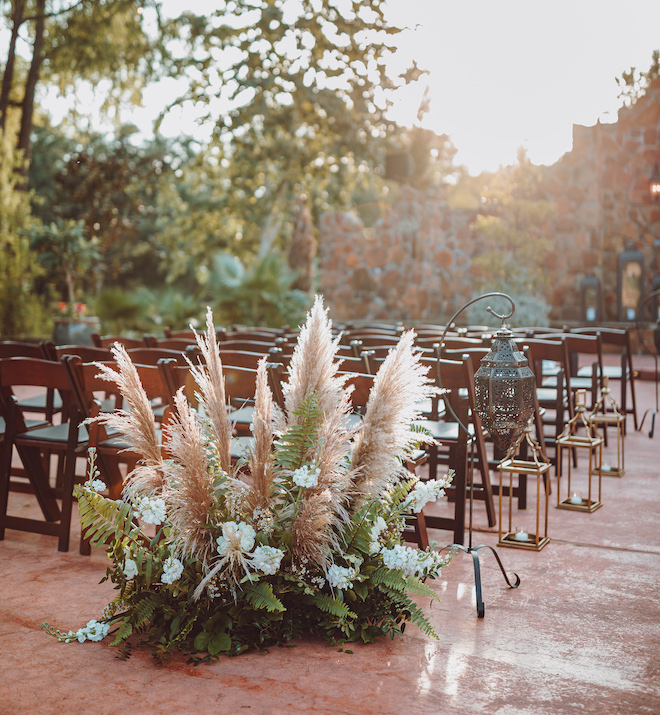 Pampas grass, greenery and white floral arrangement. 